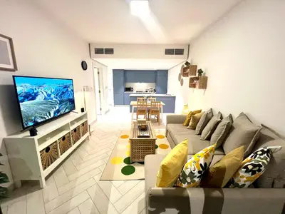 a living room with a couch and a flat screen tv at Ayla in Aqaba