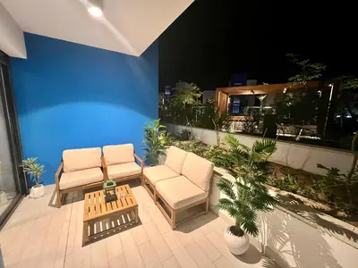 two chairs and a table on a patio at night at Ayla in Aqaba