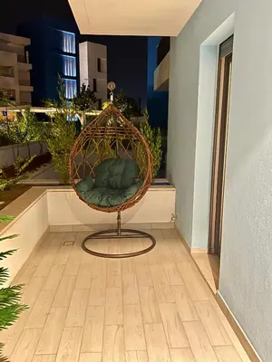 a rattan chair sitting on top of a balcony at Ayla in Aqaba