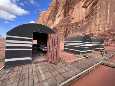a black and white camper garage in the desert at Wadi Rum Tours and Camp in Wadi Rum