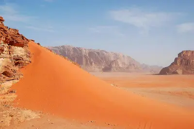 a sand dune in the middle of the desert at Wadi Rum Tours and Camp in Wadi Rum