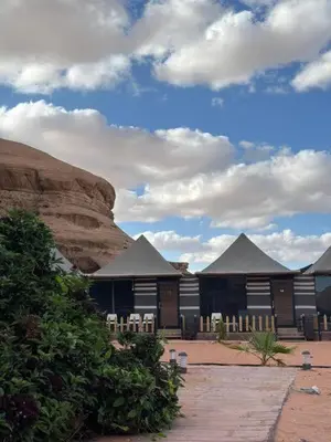 a group of buildings in the middle of a desert at Wadi Rum Salem Muhammad in Wadi Rum