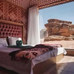 a bedroom with a bed with a teddy bear on it at Wadi Rum Salem Muhammad in Wadi Rum