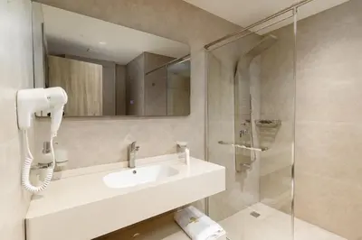 a bathroom with a sink and a shower at Golden Pillar Hotel in Aqaba
