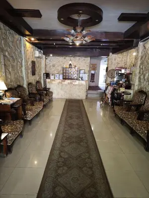 a room with a long aisle with chairs and a store at Rocky Mountain Hotel Jordan in Petra