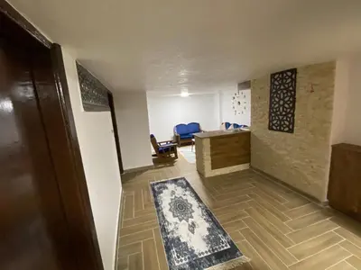 an empty room with a desk and chairs in a room at Kirakoupdolis house & restaurant in Kerak