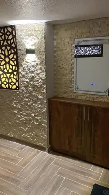 a room with a wall with a window and a microwave at Kirakoupdolis house & restaurant in Kerak