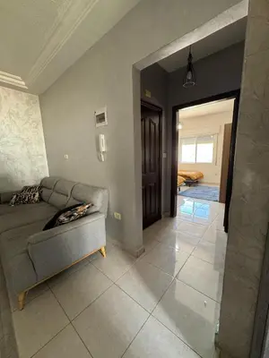 a living room with a couch and a hallway at 2bedroom-2bathroom-furniture in Amman