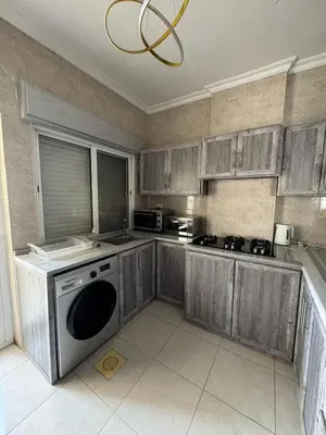 a kitchen with wooden cabinets and a dishwasher at 2bedroom-2bathroom-furniture in Amman
