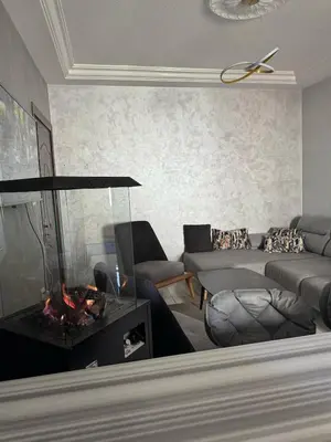 a living room with a couch and a fireplace at 2bedroom-2bathroom-furniture in Amman