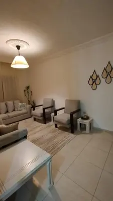 a living room with two couches and a table at حي الجامعة خلف الجامعة الاردنية in Amman