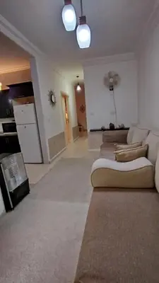 a large living room with a couch and a kitchen at حي الجامعة خلف الجامعة الاردنية in Amman