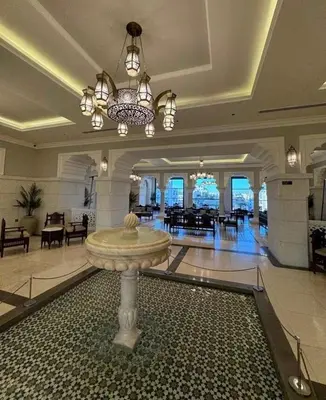a lobby with a fountain in the middle of a building at Luxury apartment for rent in BoulevardAirport Road in Amman