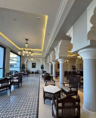 a large lobby with chairs and tables and a chandelier at Luxury apartment for rent in BoulevardAirport Road in Amman