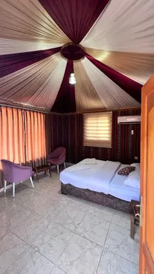a bedroom with a large bed and a ceiling at Wadi Rum Desert Memory in Wadi Rum