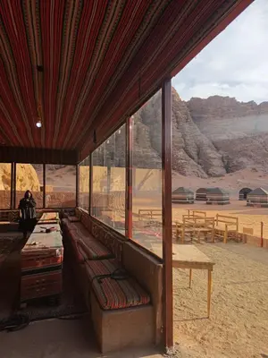 a room with a couch and a view of the desert at Bubble's Home in Wadi Rum