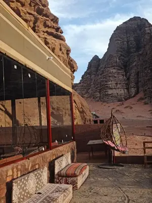 a building in the desert with a mountain in the background at Bubble's Home in Wadi Rum