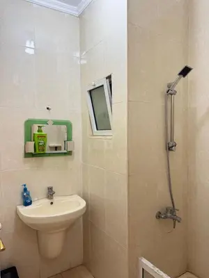 a bathroom with a sink and a toilet and a mirror at panorama sea view apartment in Sowayma