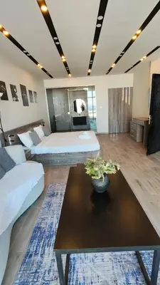 a living room with two beds and a table at LP chalet deadSea view in Sowayma