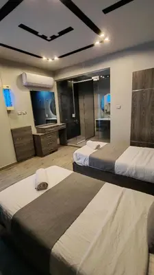 a hotel room with two beds and a television at LP chalet deadSea view in Sowayma