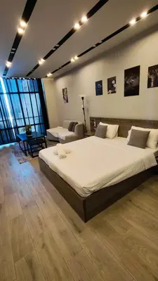 a large bedroom with a large bed and a couch at LP chalet deadSea view in Sowayma