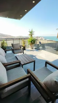 a balcony with tables and a view of the beach at LP chalet deadSea view in Sowayma