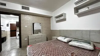 a bedroom with a bed with two pillows on it at 1 bedroom Studio in 7th circle area in Amman