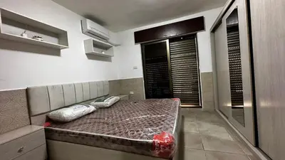 a bed with two pillows on it in a room at 1 bedroom Studio in 7th circle area in Amman