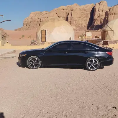 a black car is parked in the desert at سياره ليموزين in Amman