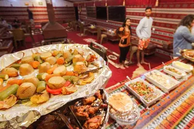 a table with many different types of food on it at Rum Cave Tours in Wadi Rum