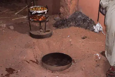 a dirty room with a grill with food on it at Rum Cave Tours in Wadi Rum