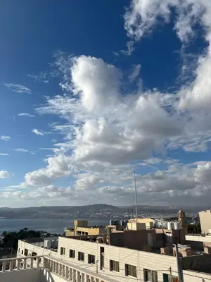 a view of a city under a cloudy sky at الحمد للاجنحة الفندقية in Aqaba