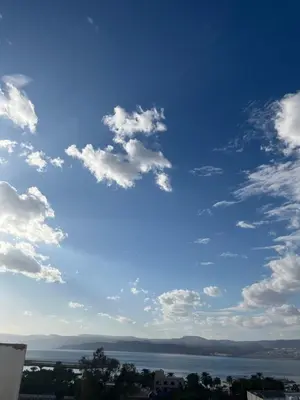 a blue sky with clouds over a body of water at الحمد للاجنحة الفندقية in Aqaba