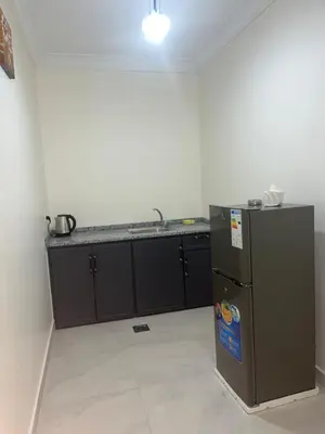 a kitchen with a refrigerator and a counter at الحمد للاجنحة الفندقية in Aqaba