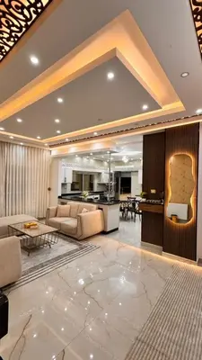 a living room with a couch and a kitchen at شقق فندقيه فخمه للايجار اليومي in Ash Shumaysānī