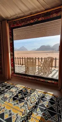 a room with a view of the desert through a window at wadi rum Bubble lunara luxury camp in Wadi Rum