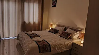 a bedroom with a bed with two pillows on it at hotel amman in Amman