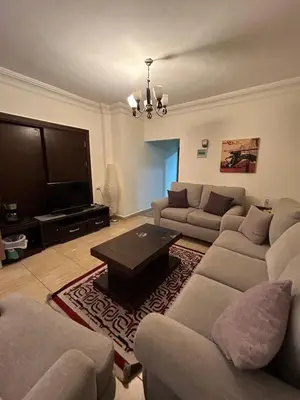 a living room with two couches and a television at Cozy 1BR in Abdoun Quiet Near US Embassy in Amman
