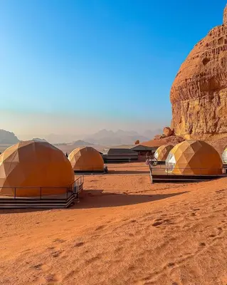 a group of tents in the desert at Rum Rose Night in Wadi Rum