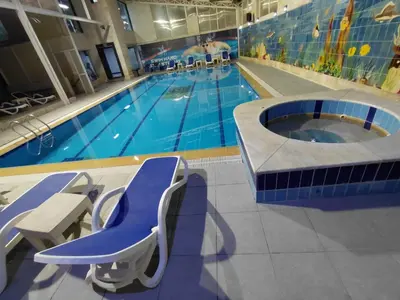 a large swimming pool with a blue swimming pool at Badan Suites & Hotel in Amman