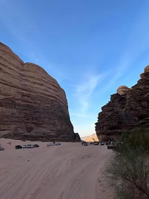a group of cars parked in the desert near rocks at Nile bedouin camp in Aqaba