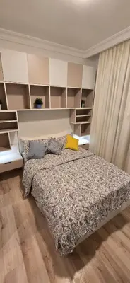 a bedroom with a bed and shelves in it at Rainbow 7 in Amman