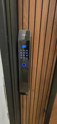 a remote control hanging on a wooden wall at Rainbow 7 in Amman