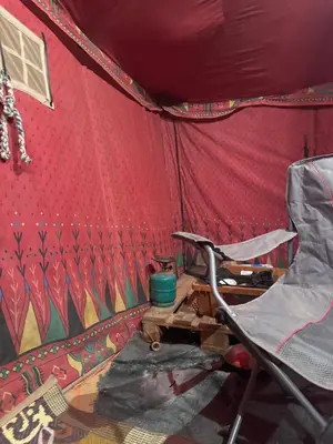 a chair in front of a red tent at RUM LOREN lUXURY CAMP in Wadi Rum