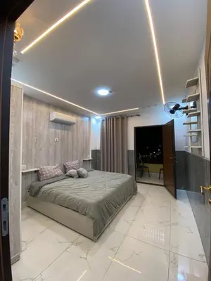 a bedroom with a large bed and a fireplace at Avatar Hotel-Aqaba in Aqaba