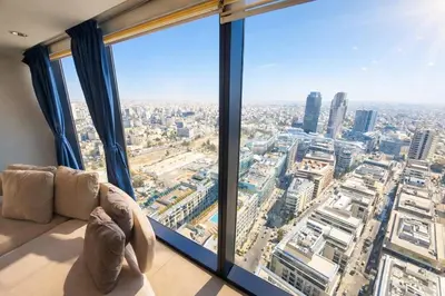 a living room with a view of a city at Skyline Residence Apartment Stunning City Views in Amman