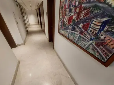 a hallway with a painting of a shopping cart at Skyline Residence Apartment Stunning City Views in Amman