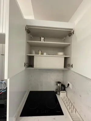 a kitchen with a stove top oven in a kitchen at Boulevard Comfort Haven, apt with stunning veiw in Amman