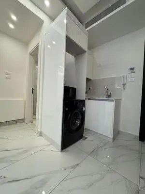 a laundry room with a washing machine in it at Boulevard Comfort Haven, apt with stunning veiw in Amman