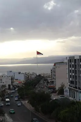 a view of a city with a flag on a pole at Mariam Economy Hotel in Aqaba